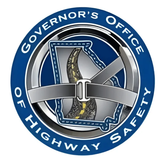 Blue circular logo for the Governor’s Office of Highway Safety, featuring Georgia’s outline and a seatbelt graphic across the state.